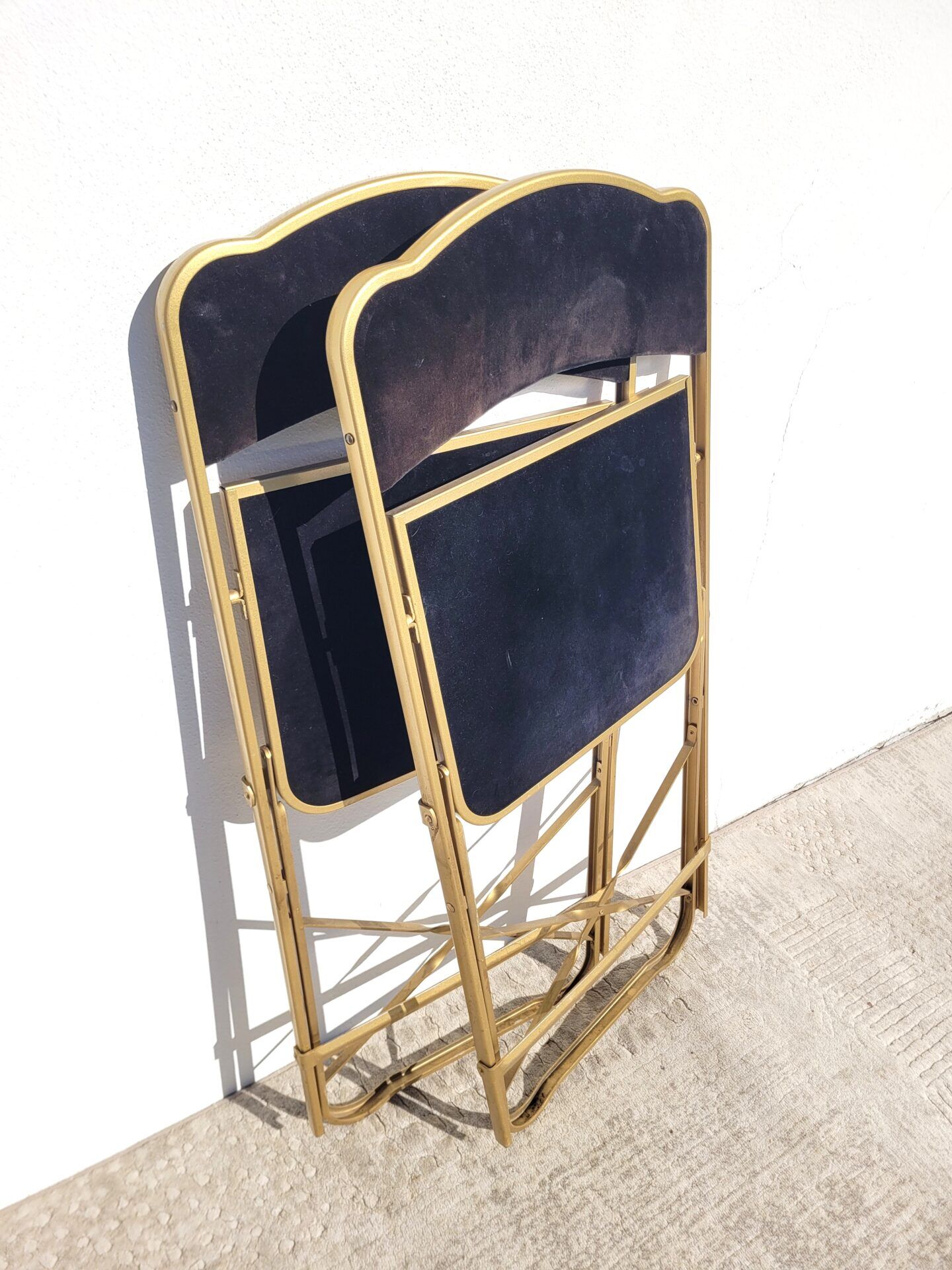 Pair of black and gold folding opera chairs