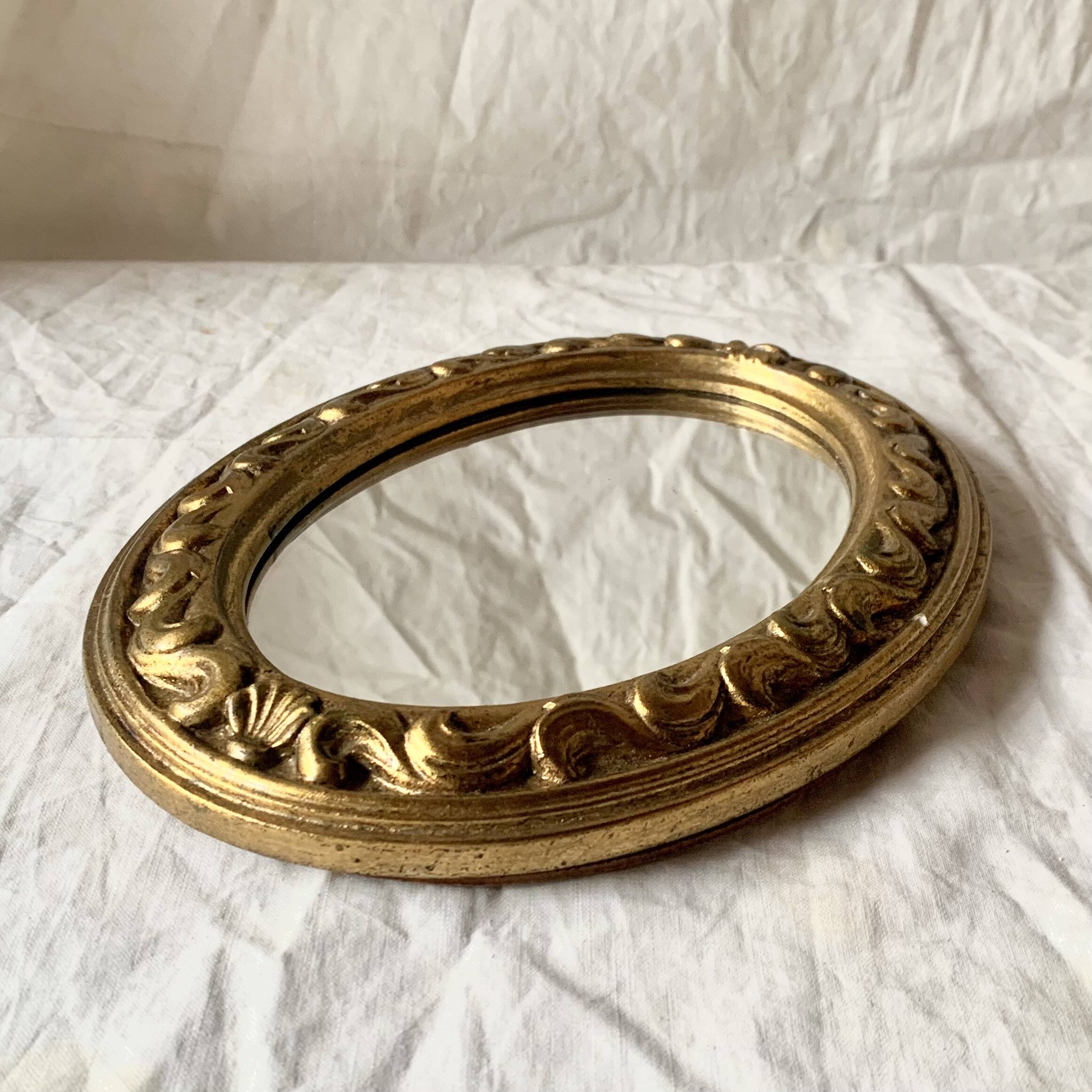 Small vintage wall mirror in gold resin