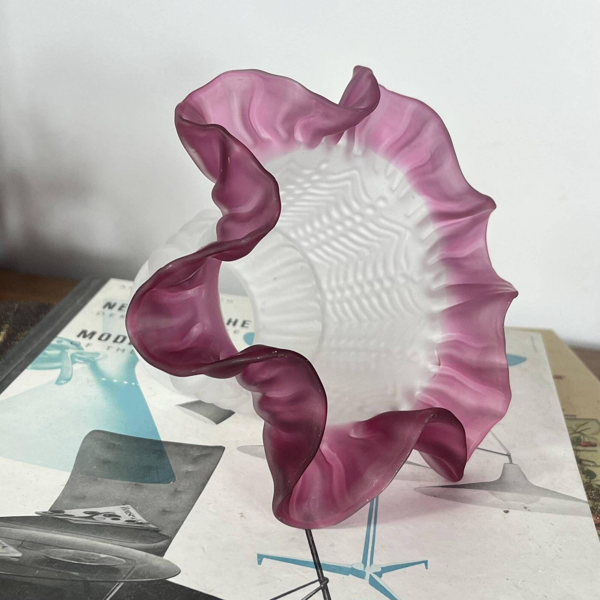Antique tulip lampshade in transparent glass with a red rim.