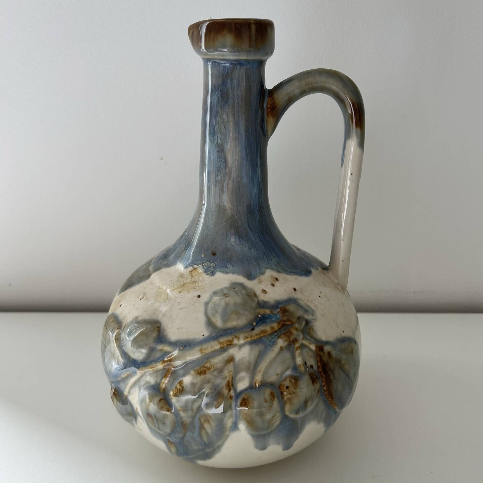 Cherry-decorated earthenware carafe