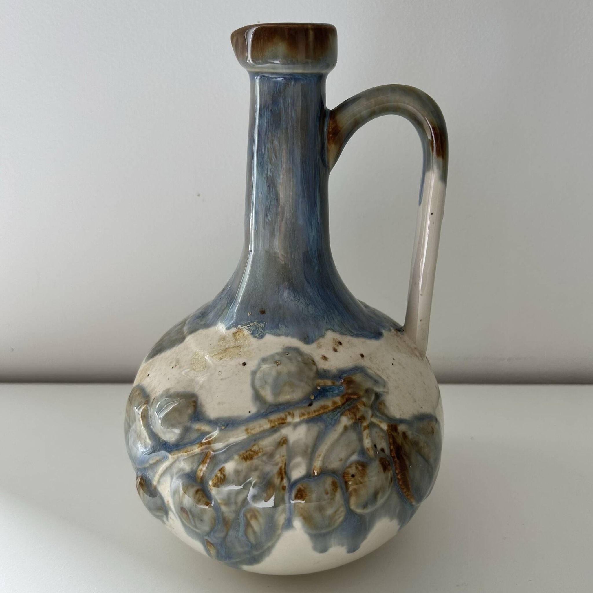 Cherry-decorated earthenware carafe