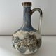 Cherry-decorated earthenware carafe