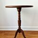 Small tripod wooden table with a vintage round top -