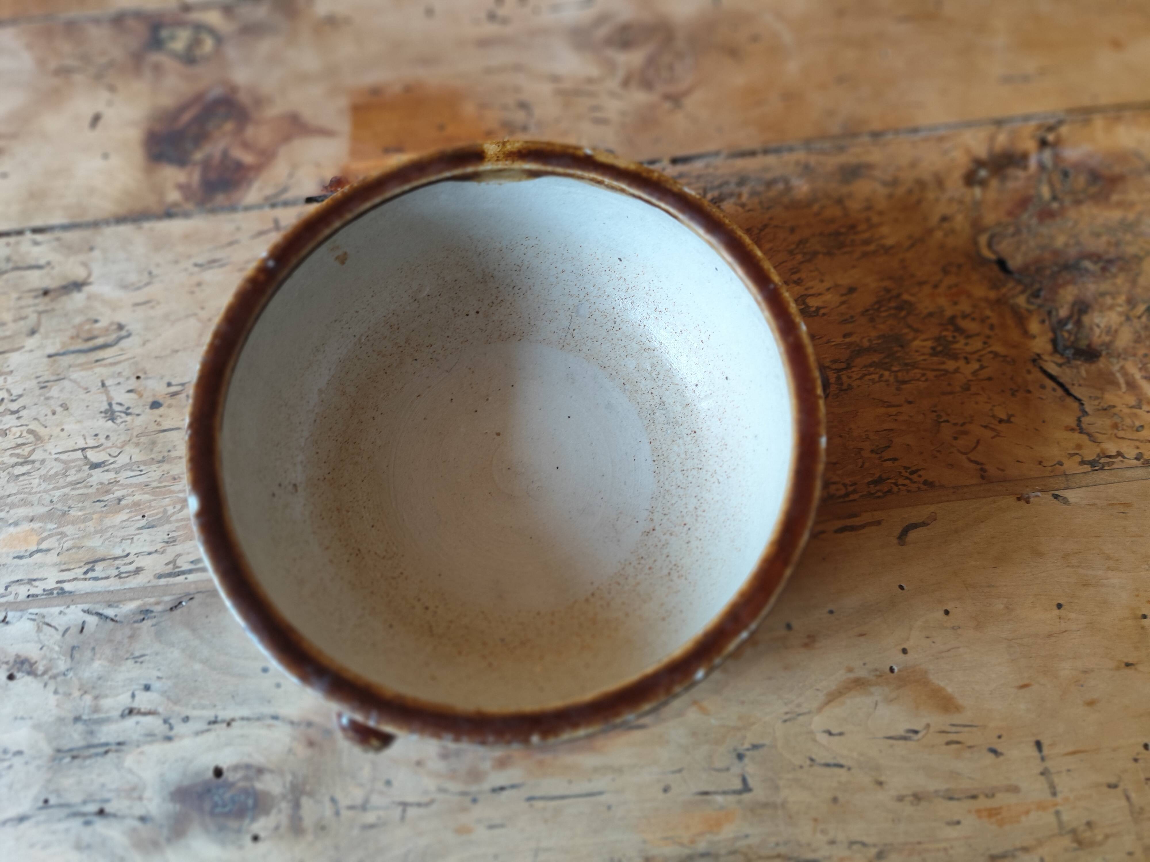 Old small glazed ceramic dish with lion head decoration - brown enamel kitchen bowl