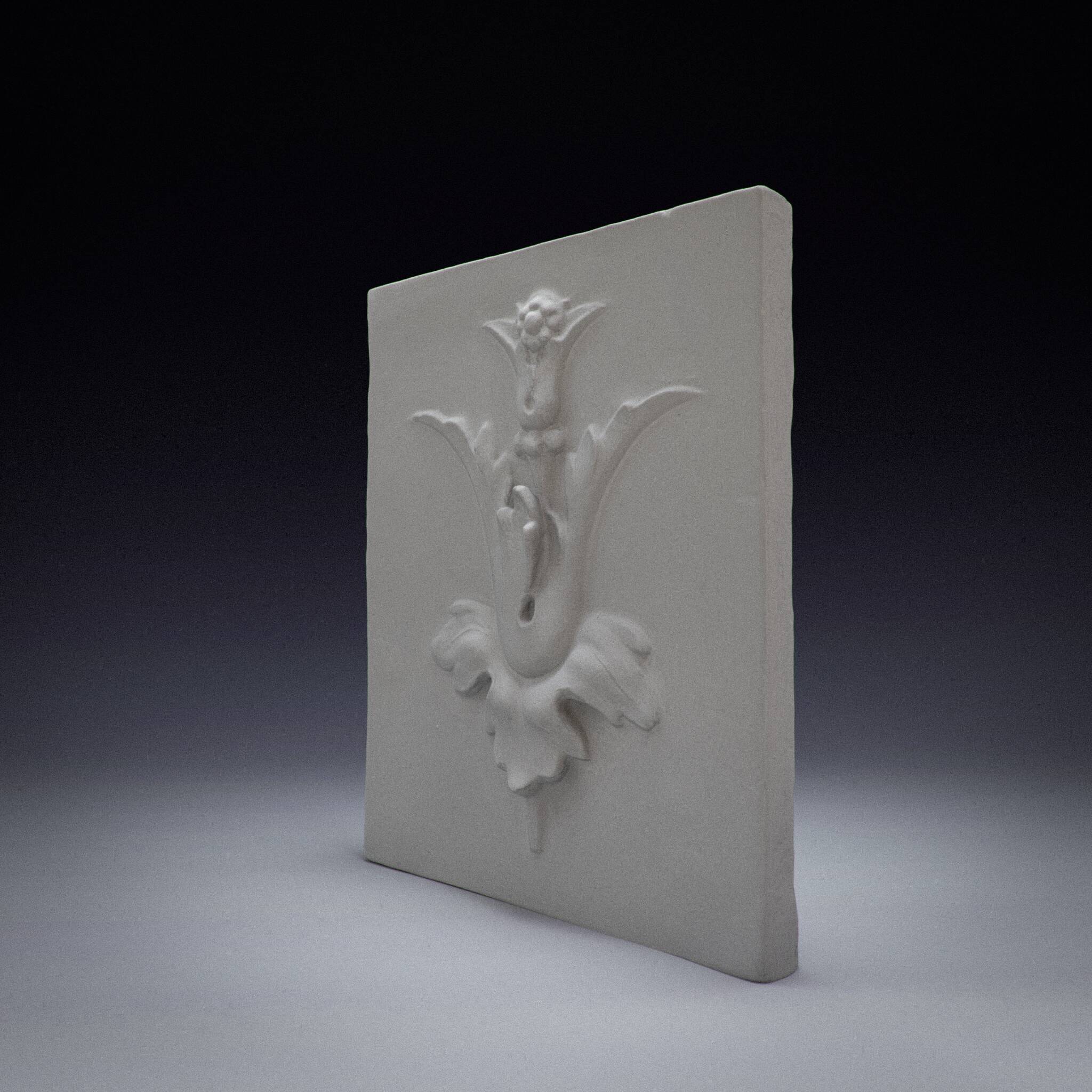 Bas-relief plaster mural with a fleur-de-lis design.