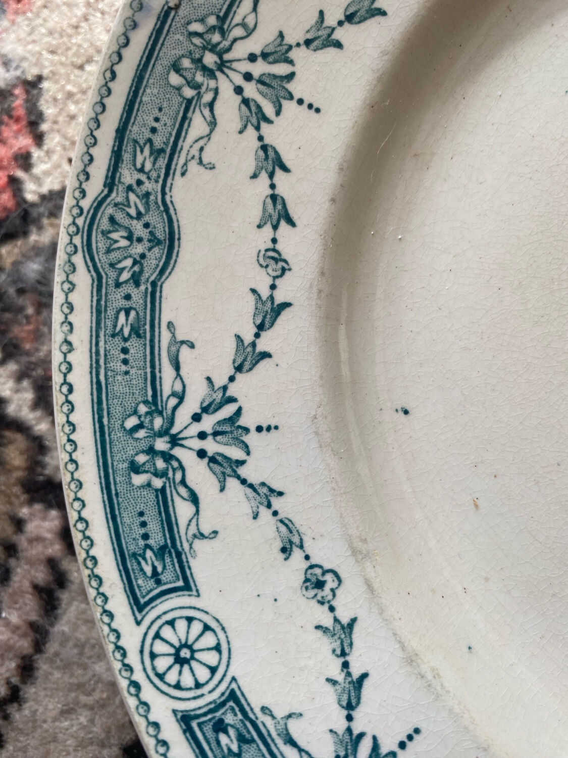 3 flat plates in ironstone with a floral green border.