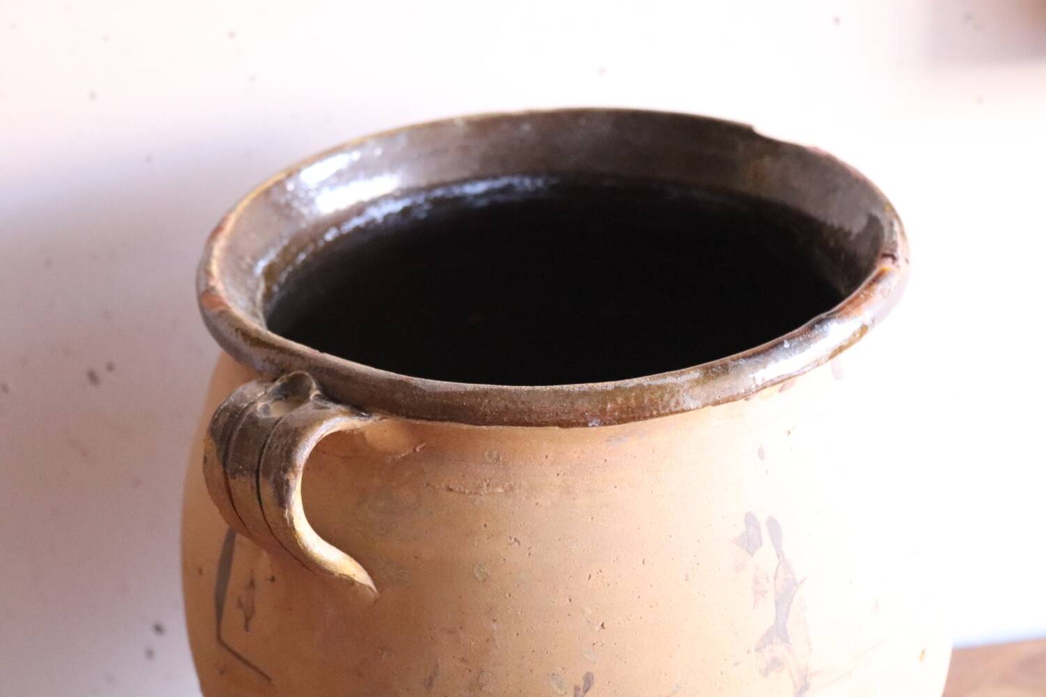 Old glazed terracotta olive jar