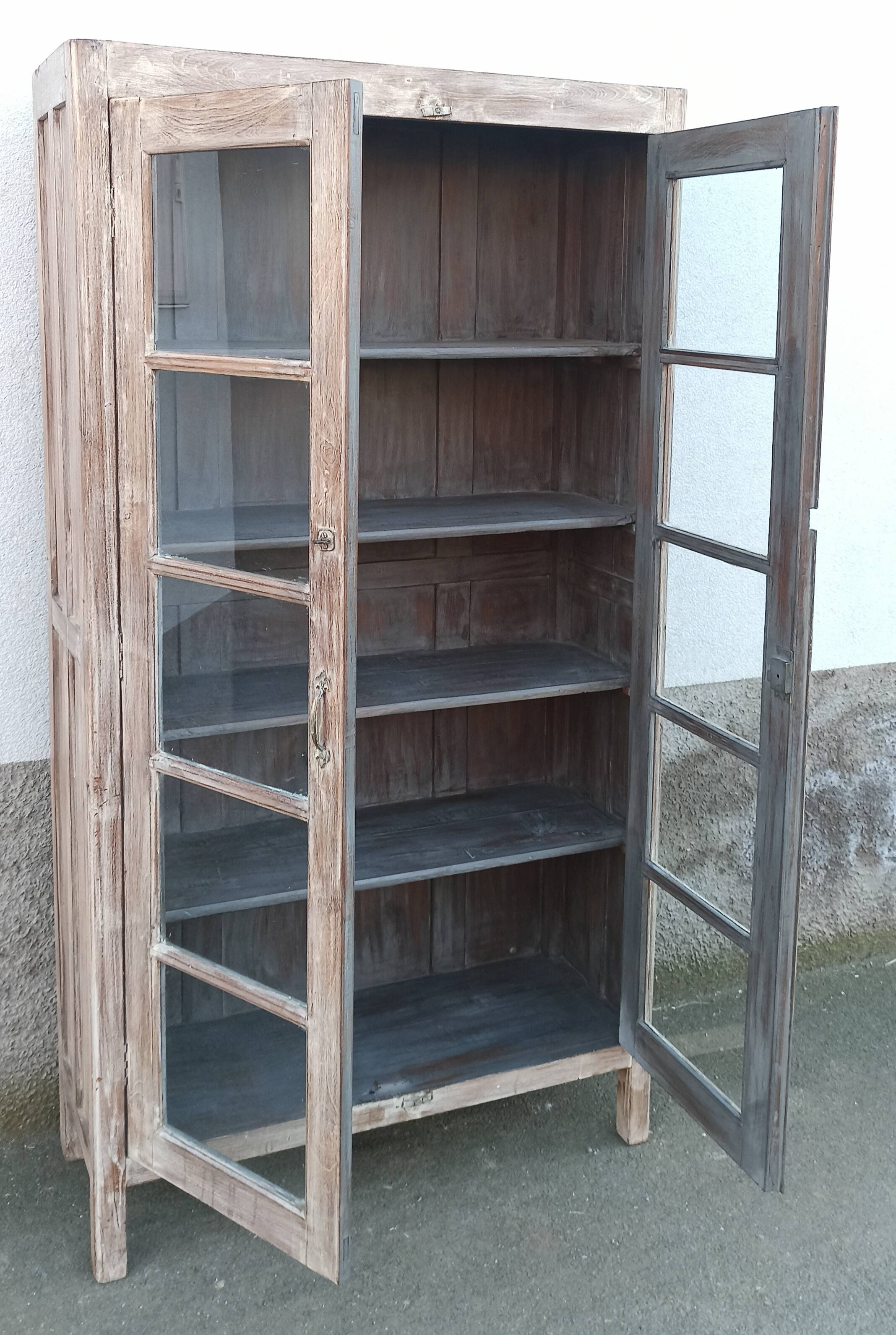 Glass cabinet in old whitewashed wood