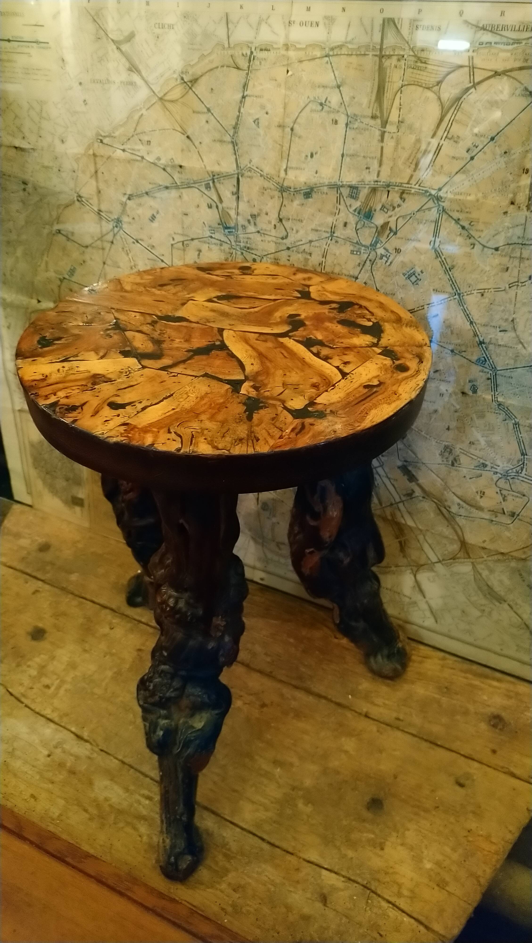 Brutalist tripod stool made from vine stumps.