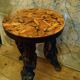 Brutalist tripod stool made from vine stumps.