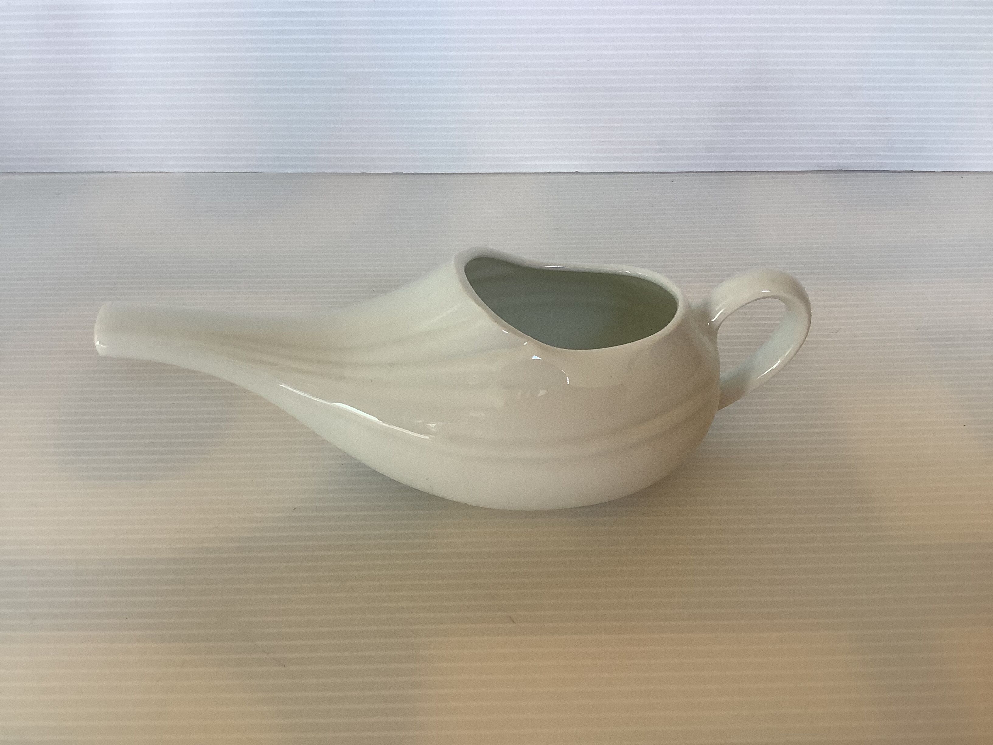 Old white porcelain baby bottle sauceboat