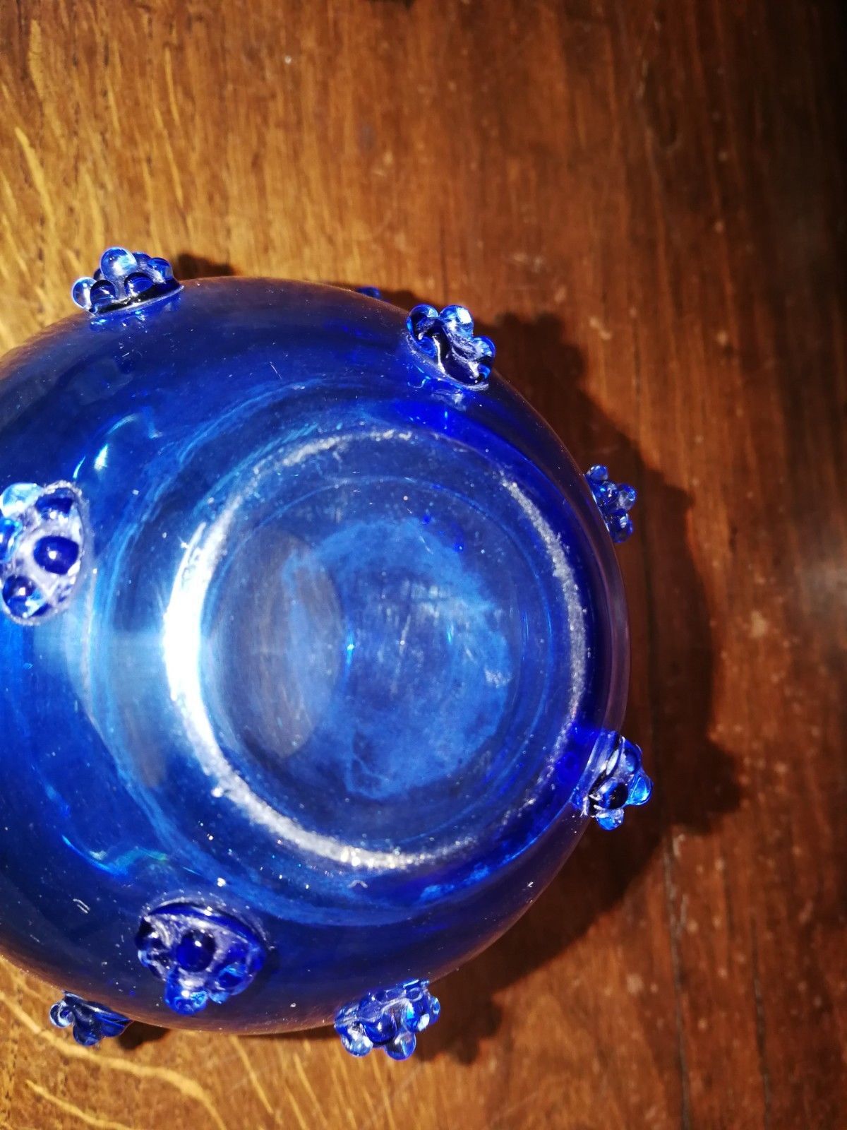 Blue glass vase to button in application