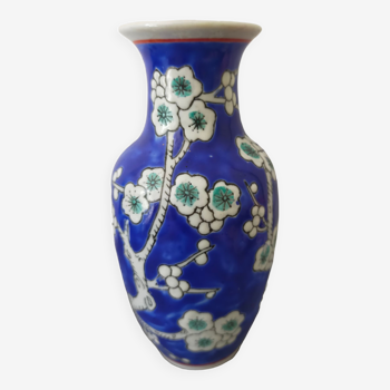 Small blue ceramic vase with cherry wood decoration