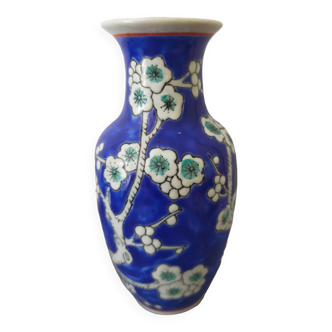 Small blue ceramic vase with cherry wood decoration
