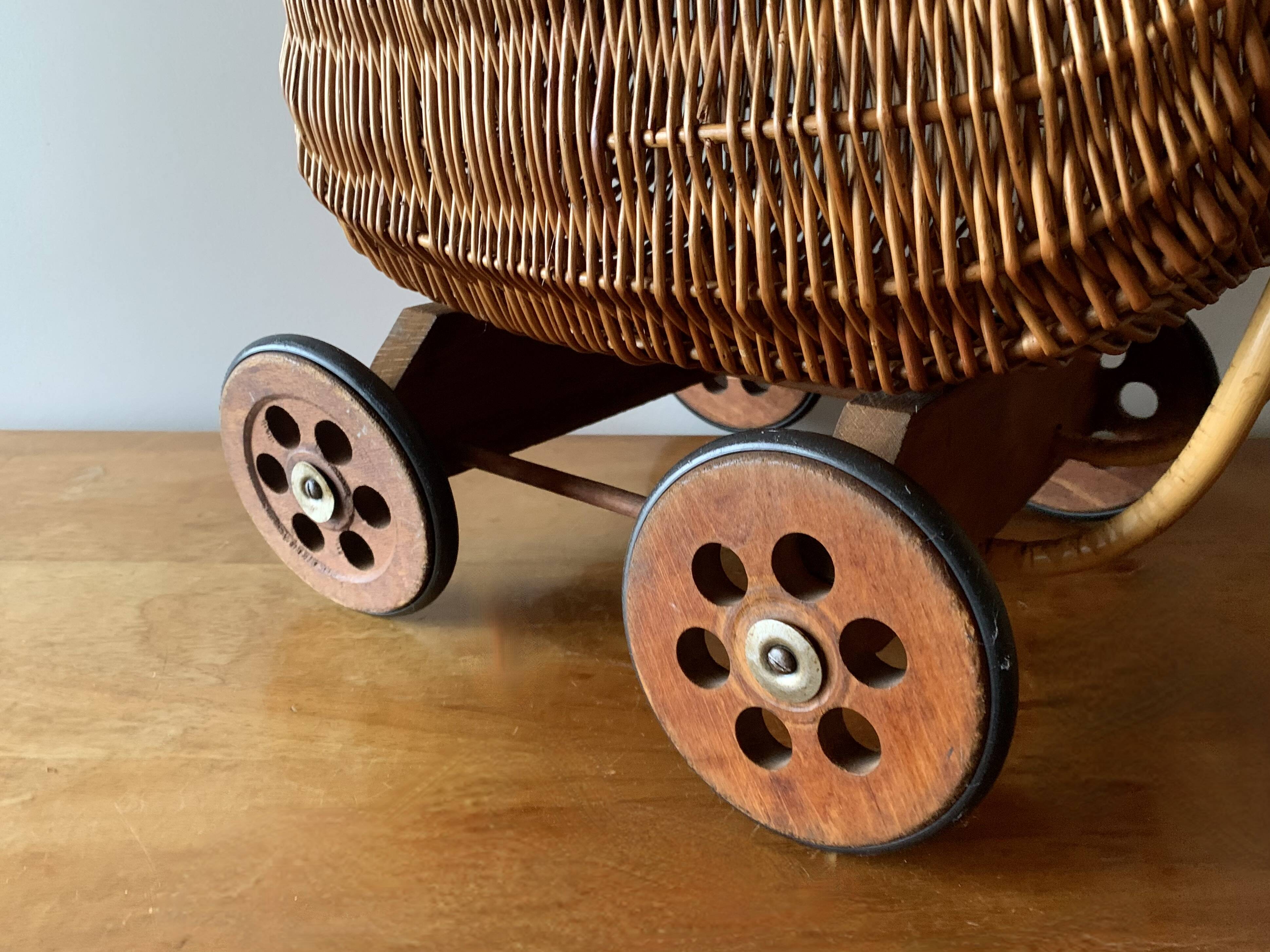 Old wicker dolls' pram - wooden wheels