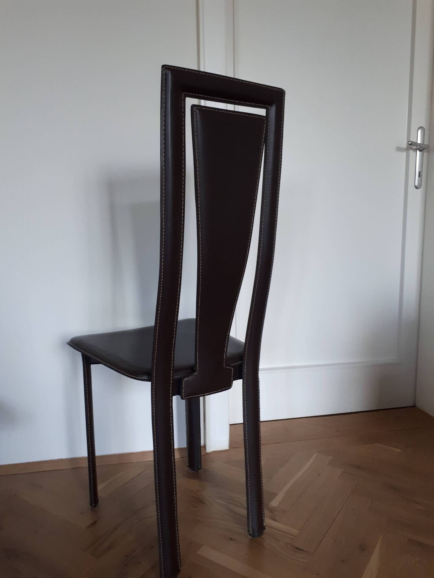 Set of 6 wooden chairs covered in leather.