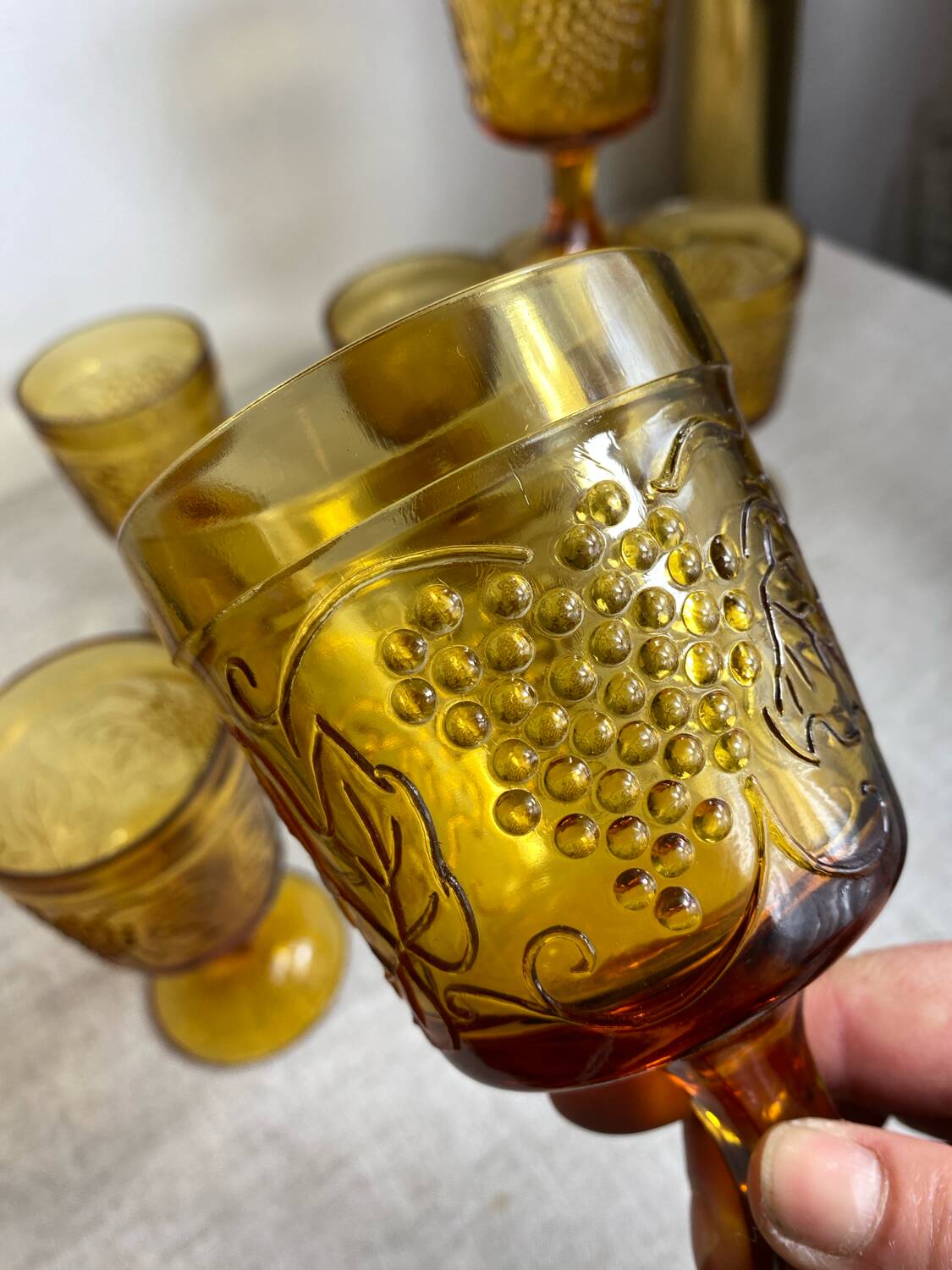 Six stemmed glasses in amber-colored molded glass
