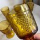 Six stemmed glasses in amber-colored molded glass