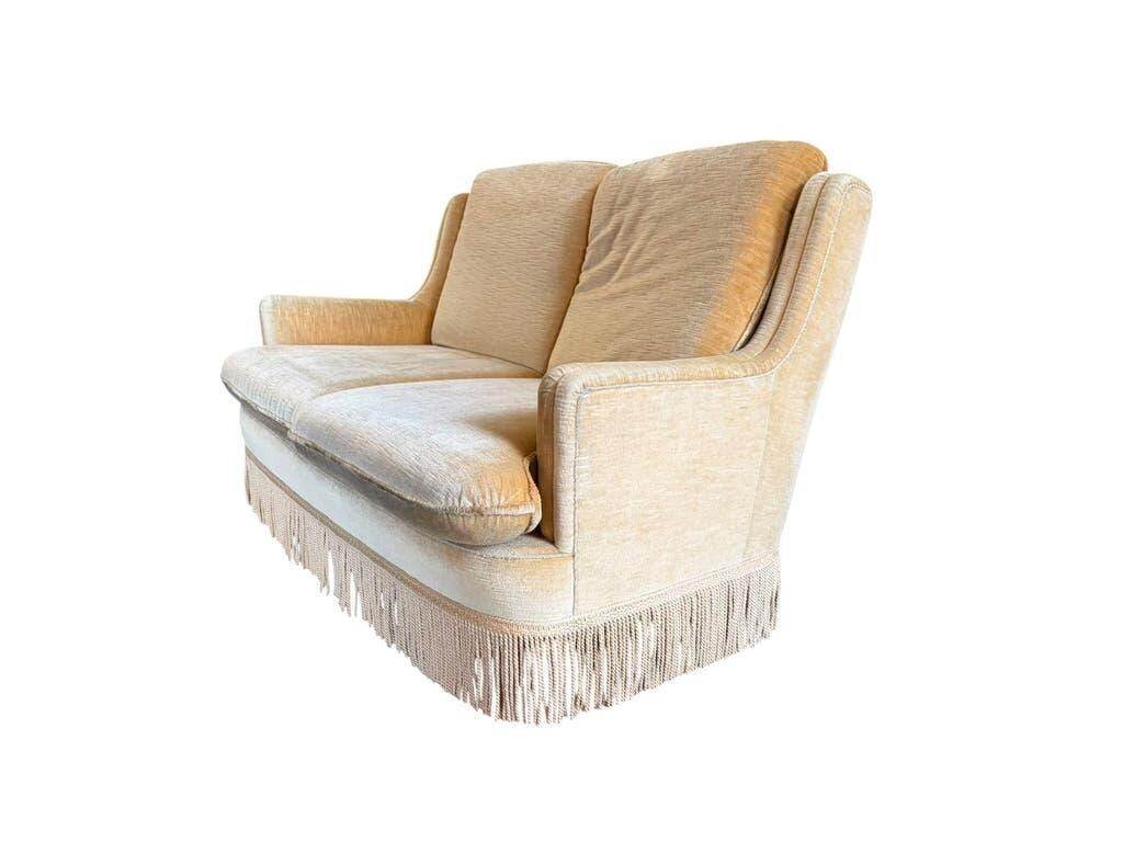 Vintage beige two-seater sofa with fringes