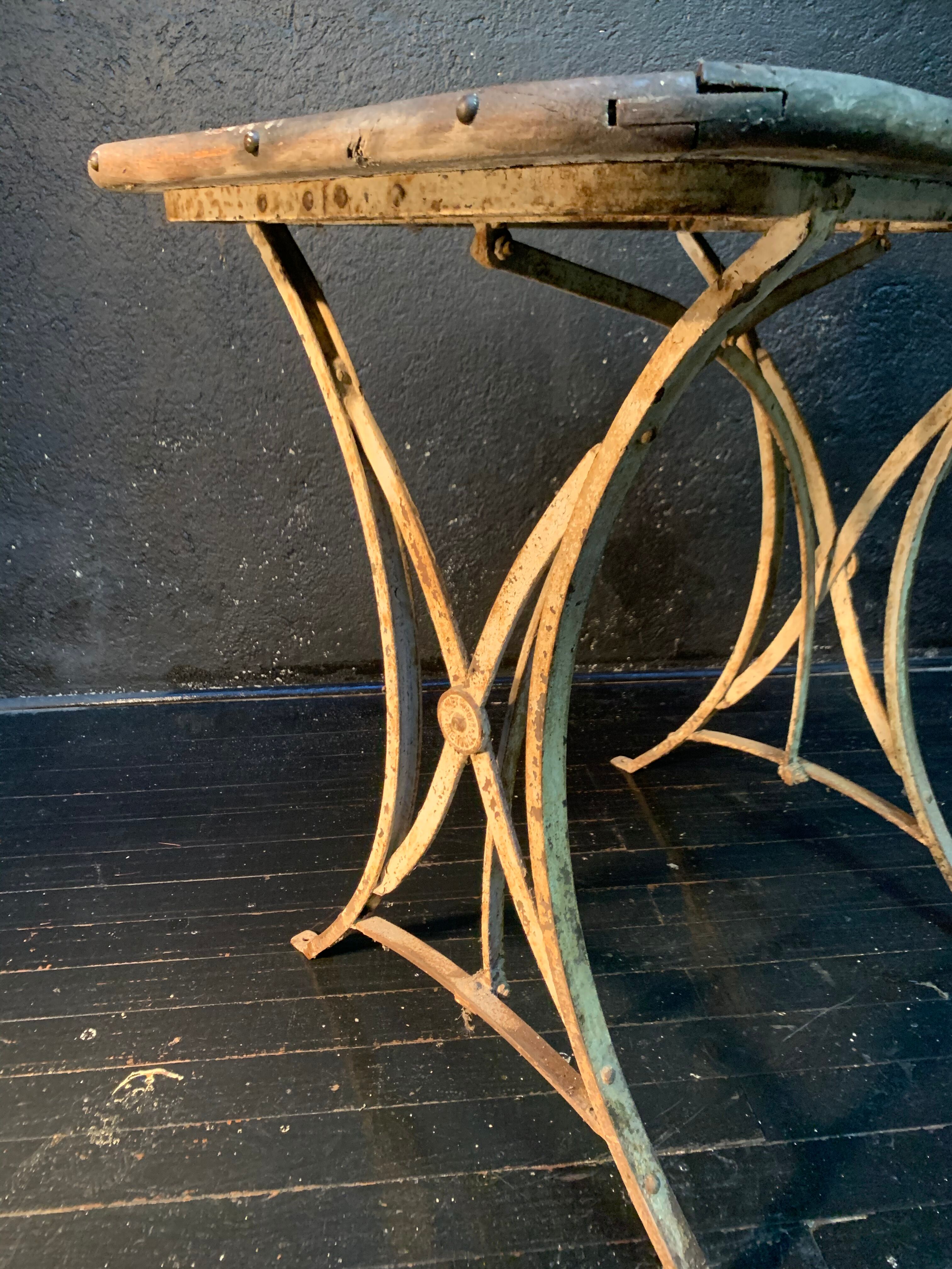 Ancient wrought iron and wood garden table