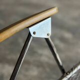 Pair of vintage silver aluminum wire folding chairs with wooden armrests — industrial minimalist