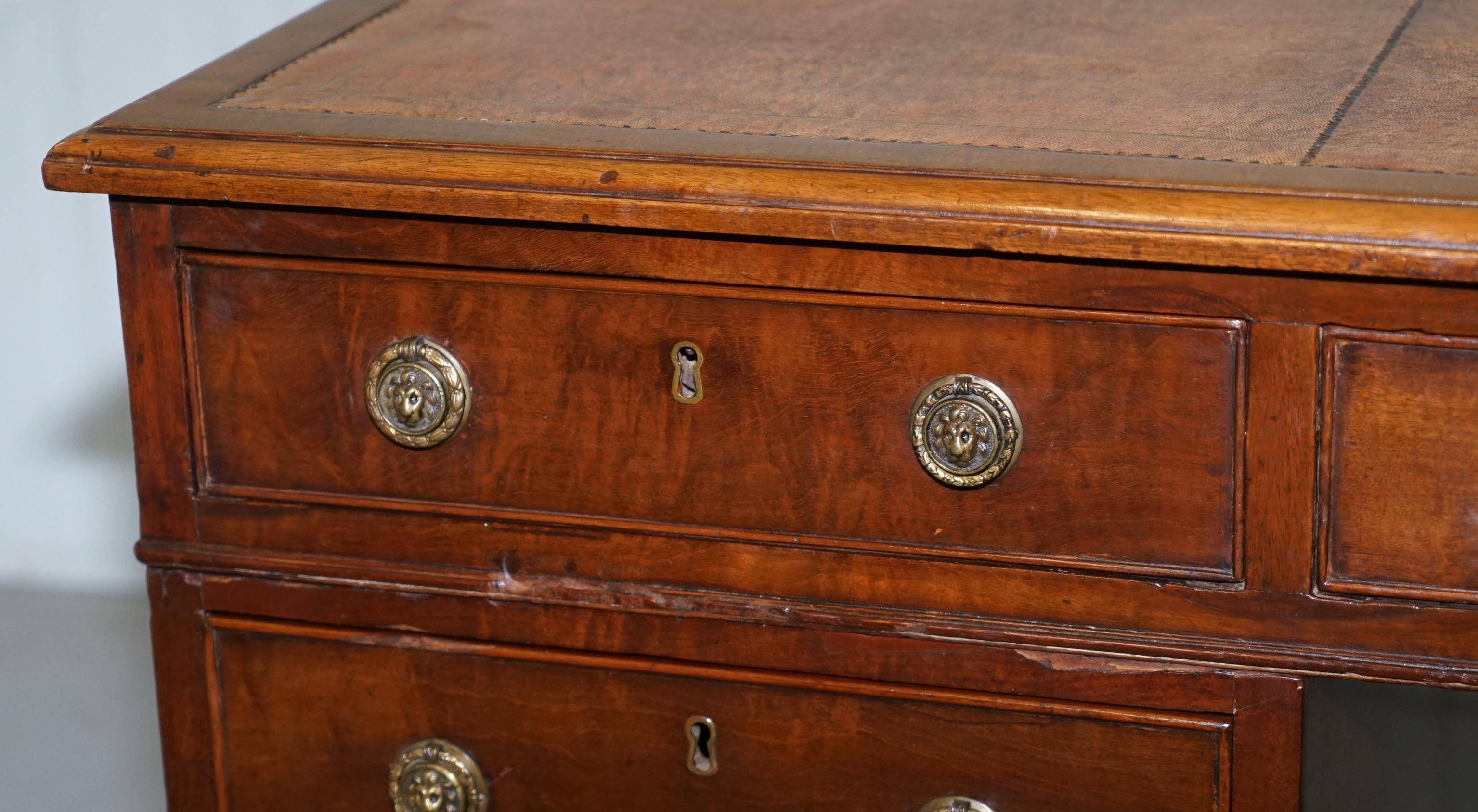 Double-sided partner's desk in walnut, George III, circa 1780, with lion head handles.