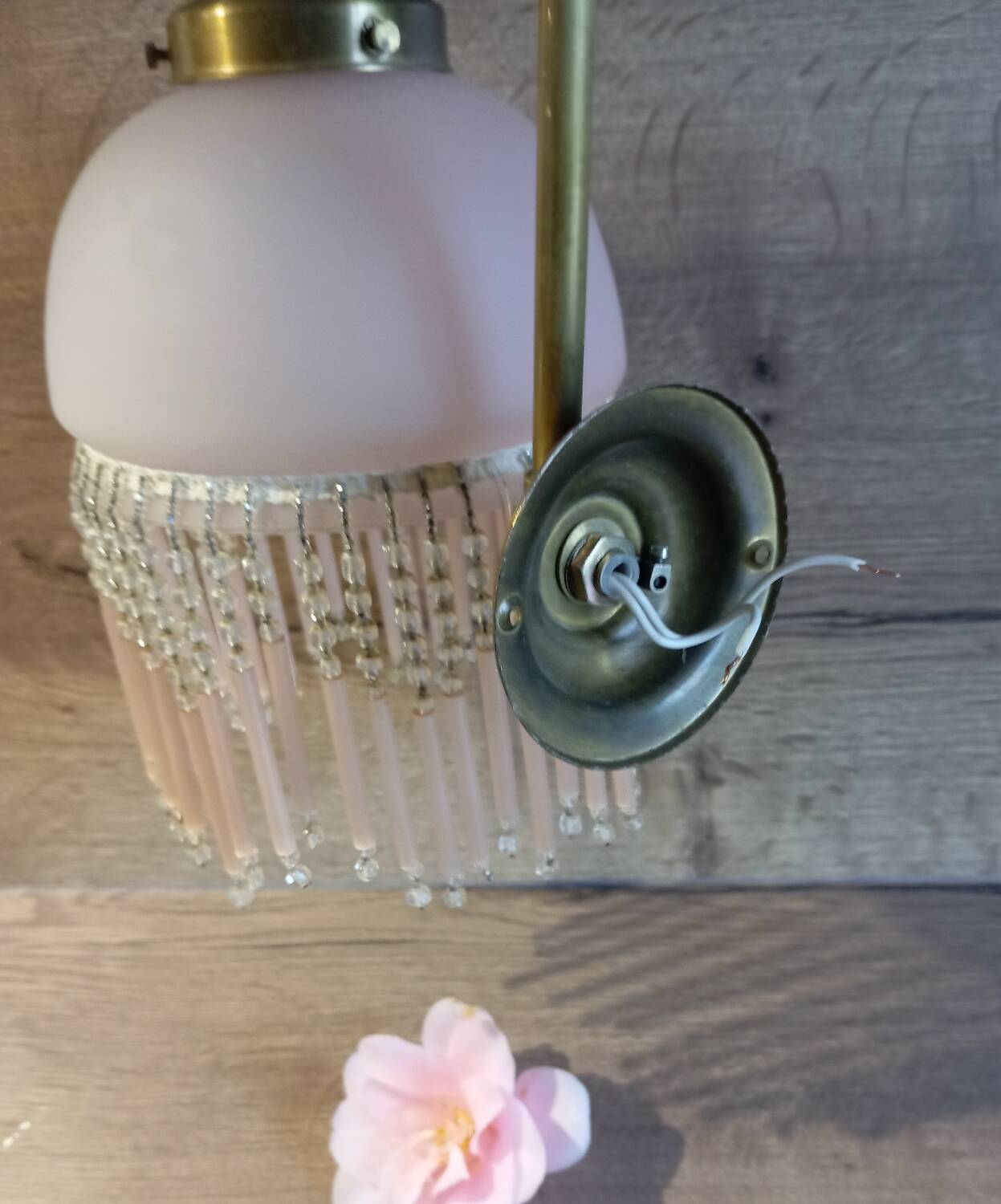 Brass swan neck wall lamp with pink glass globe and Charleston tassels