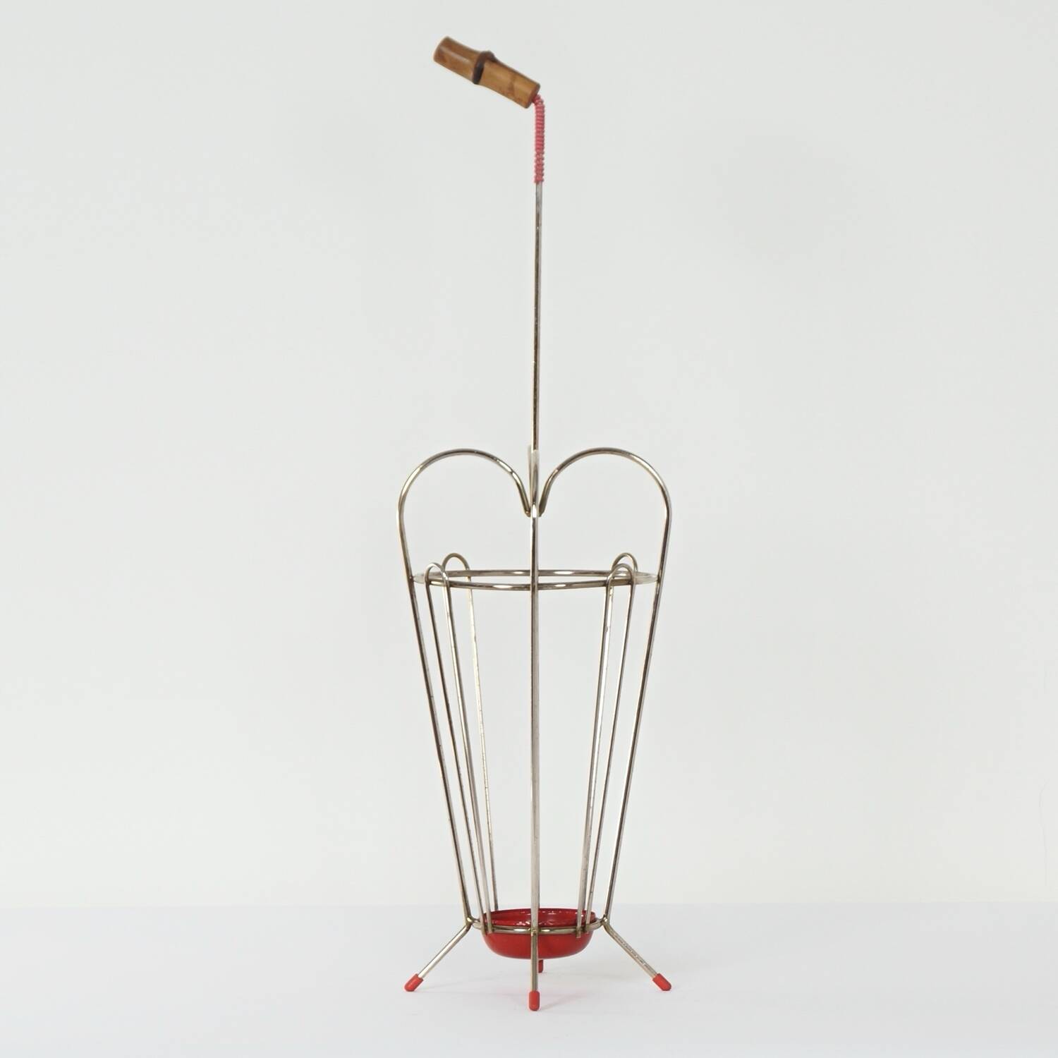 VINTAGE UMBRELLA STAND OF CURVED METAL, RED DETAILS AND A BAMBOO HANDLE, 1950S