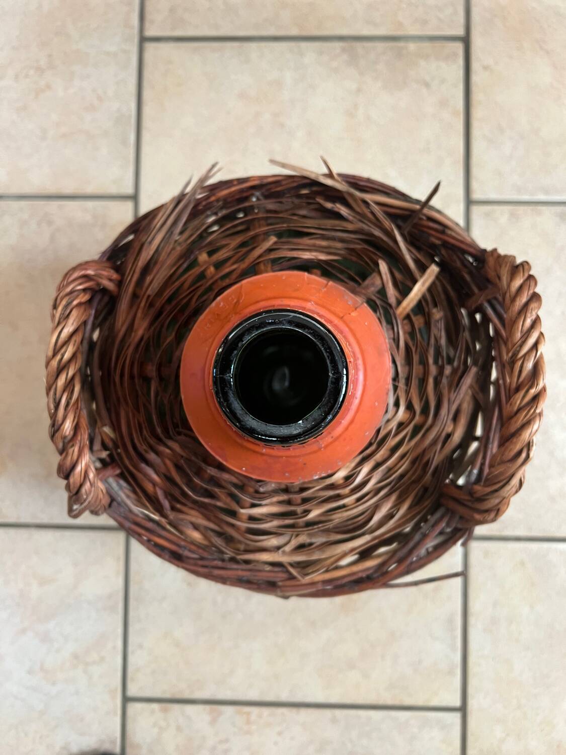Old glass demijohn with wicker basket.