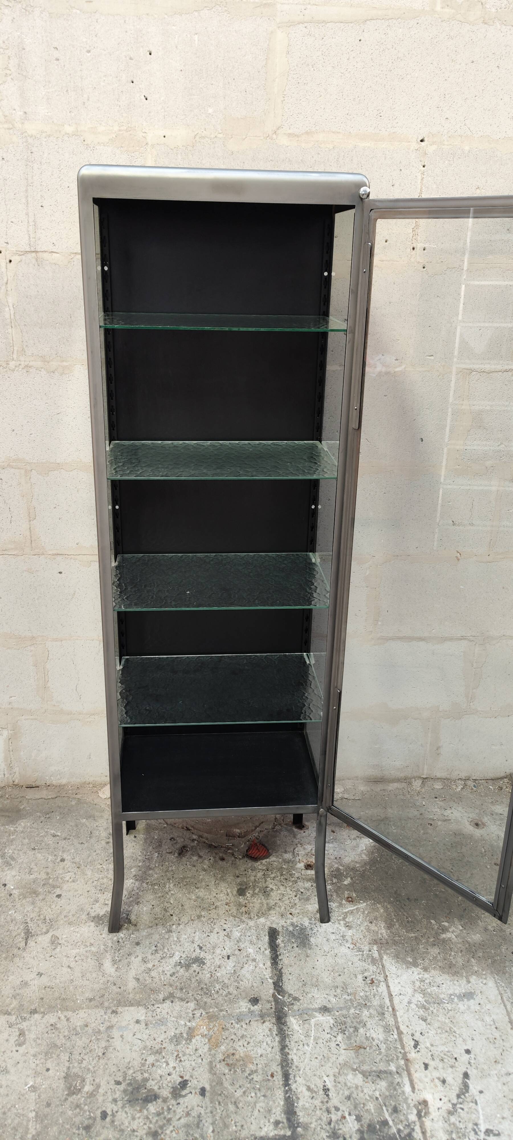 old medical display case with a graphite metal door
