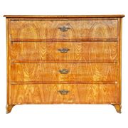 Large antique Biedermeier-style chest of drawers with wood grain.