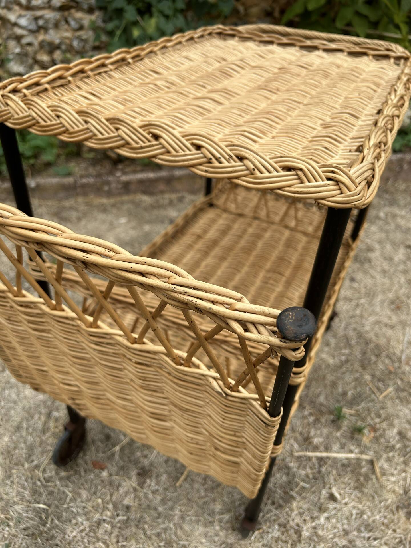 Vintage 1950s rolling dessert trolley in wicker and black tubing.