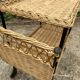Vintage 1950s rolling dessert trolley in wicker and black tubing.