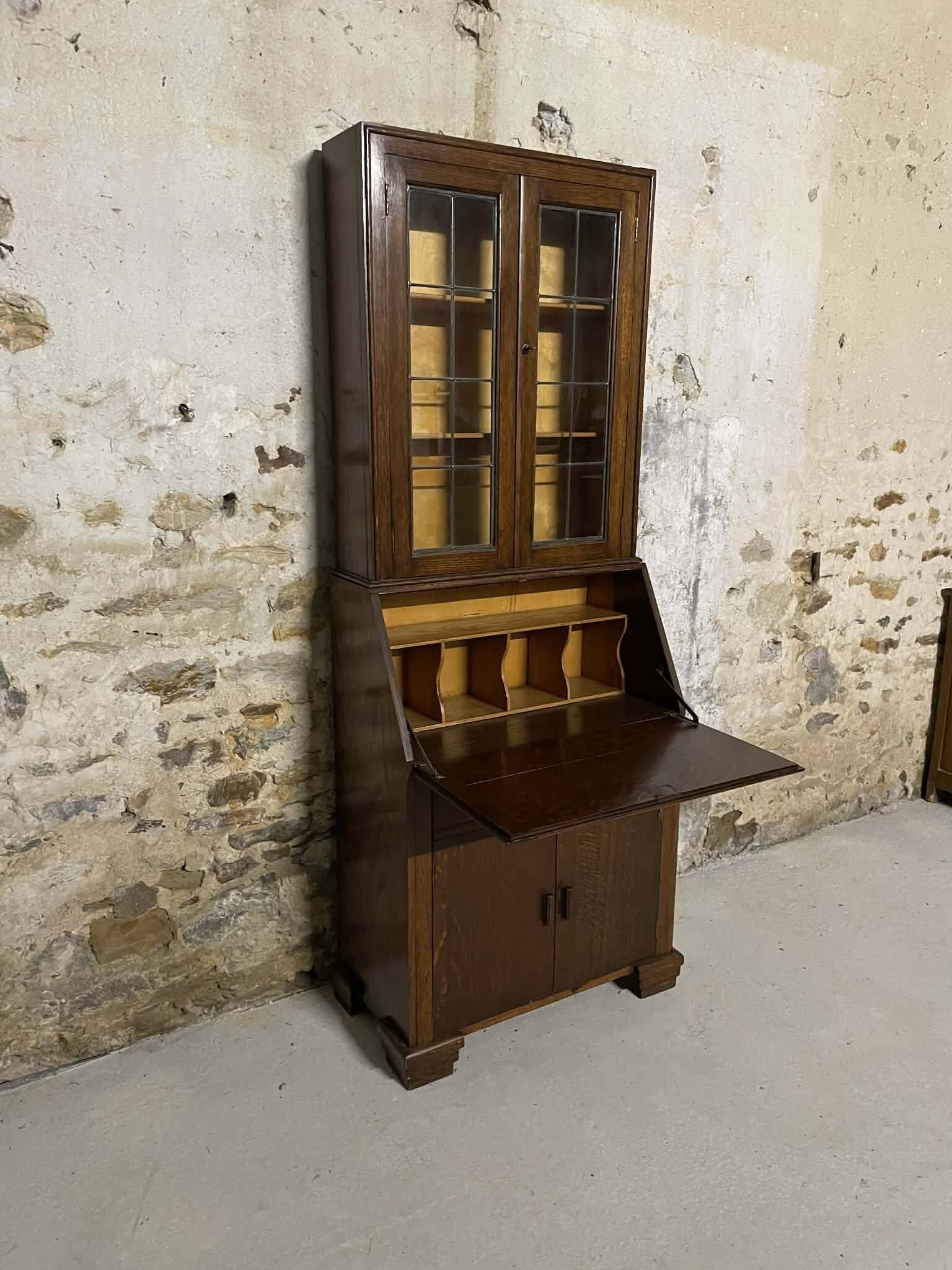 Oak display secretary cabinet with drop-down front, two sections.