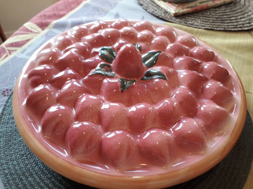 Glazed ceramic dessert plate with strawberry design.