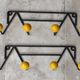 Two vintage metal and wood ball coat racks
