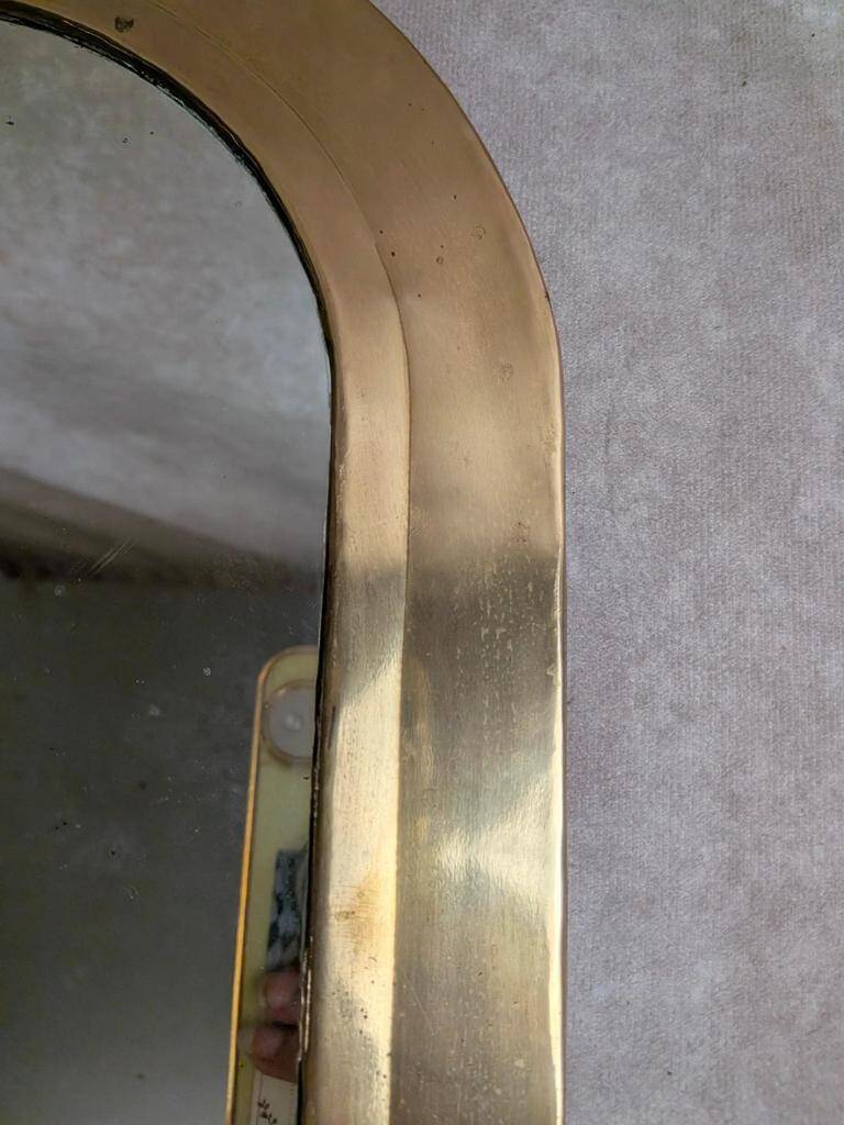 Vintage Moroccan wall mirror in brass, arch shape.