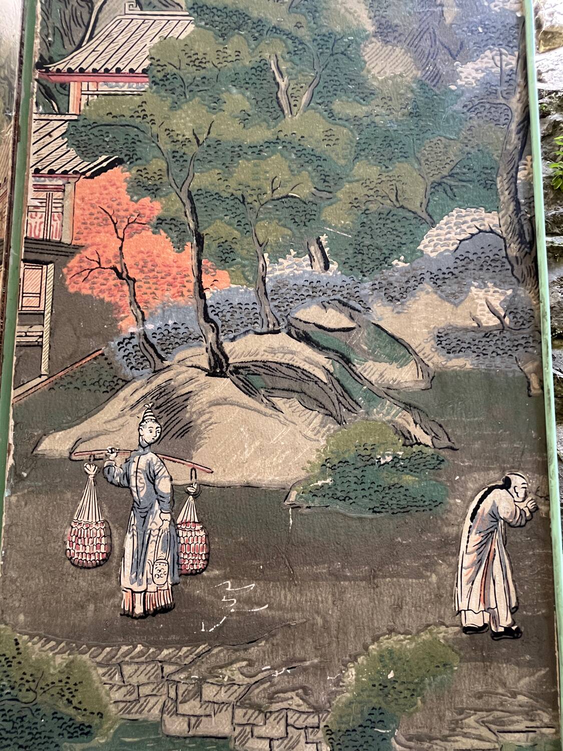 Wooden screen in Asian style, covered with Chinese wallpaper.