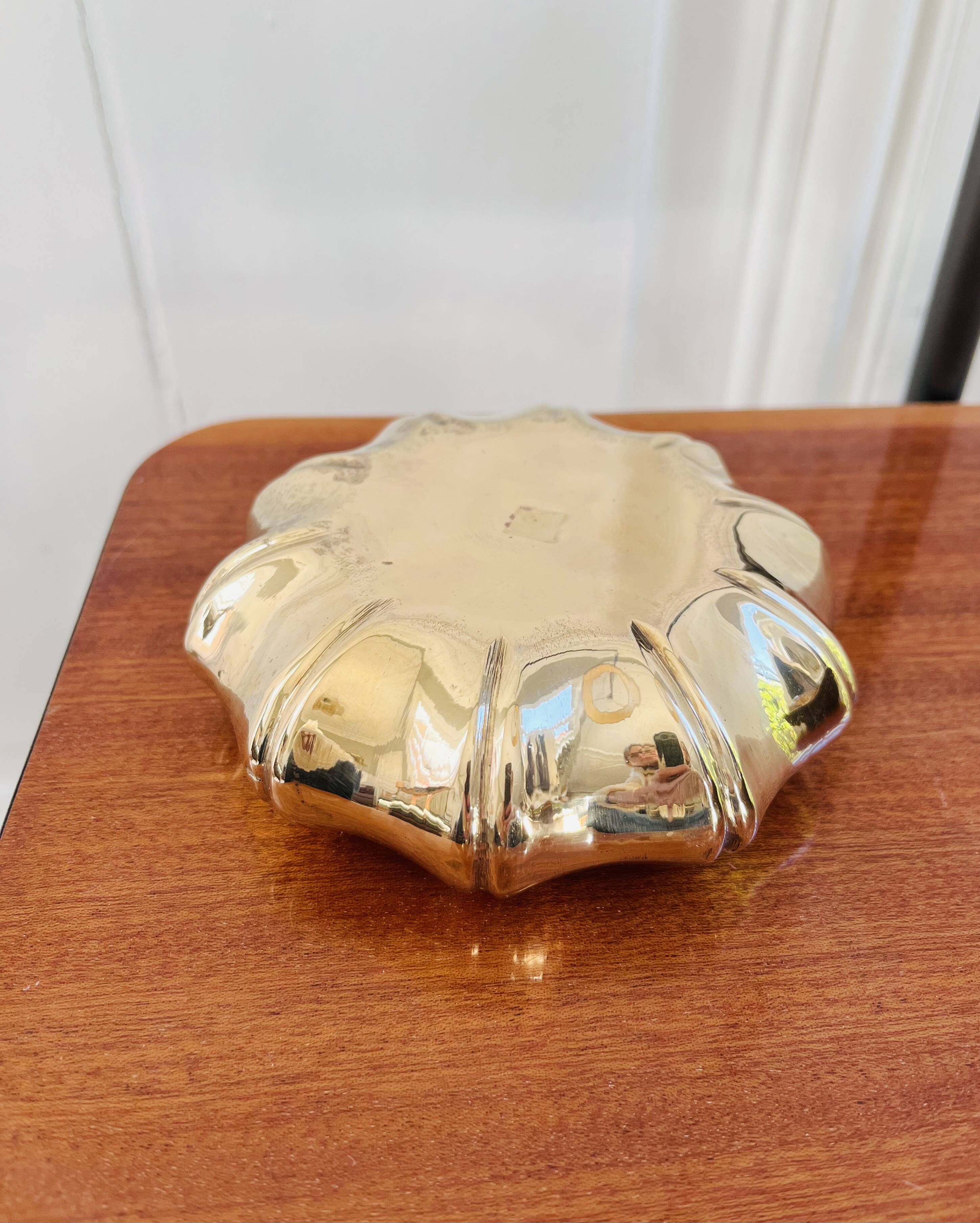 Golden brass ashtray with bamboo decoration.