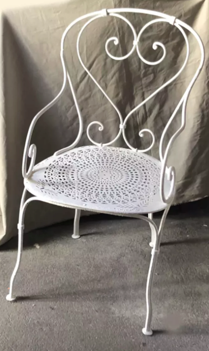 White openwork wrought iron armchair