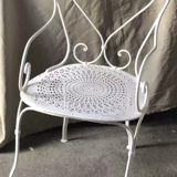 White openwork wrought iron armchair