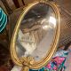 Oval mirror in gilded wood