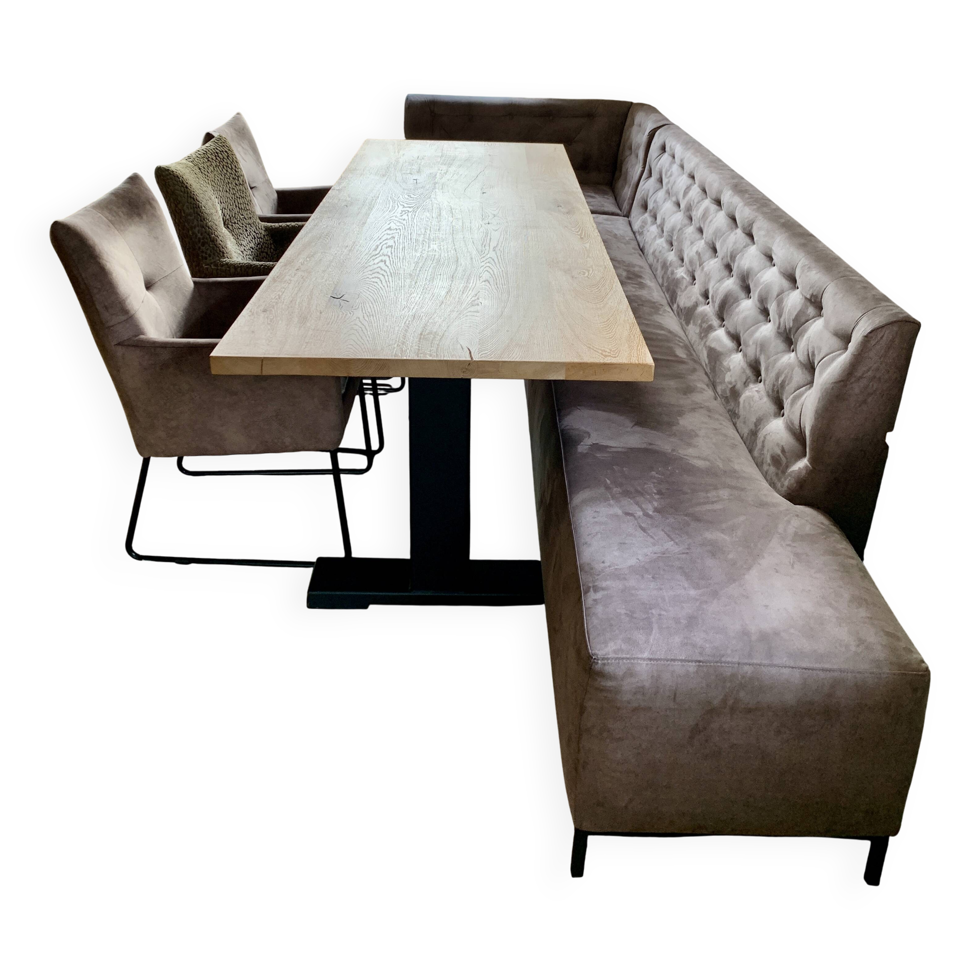 Dining table made of wood with three leather seats and a long leather sofa.