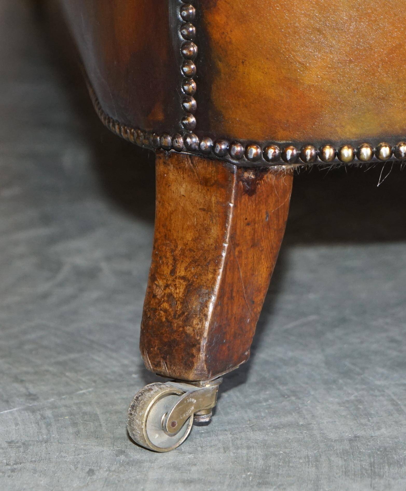 Pair of leather Chesterfield sofas by Howard & Sons