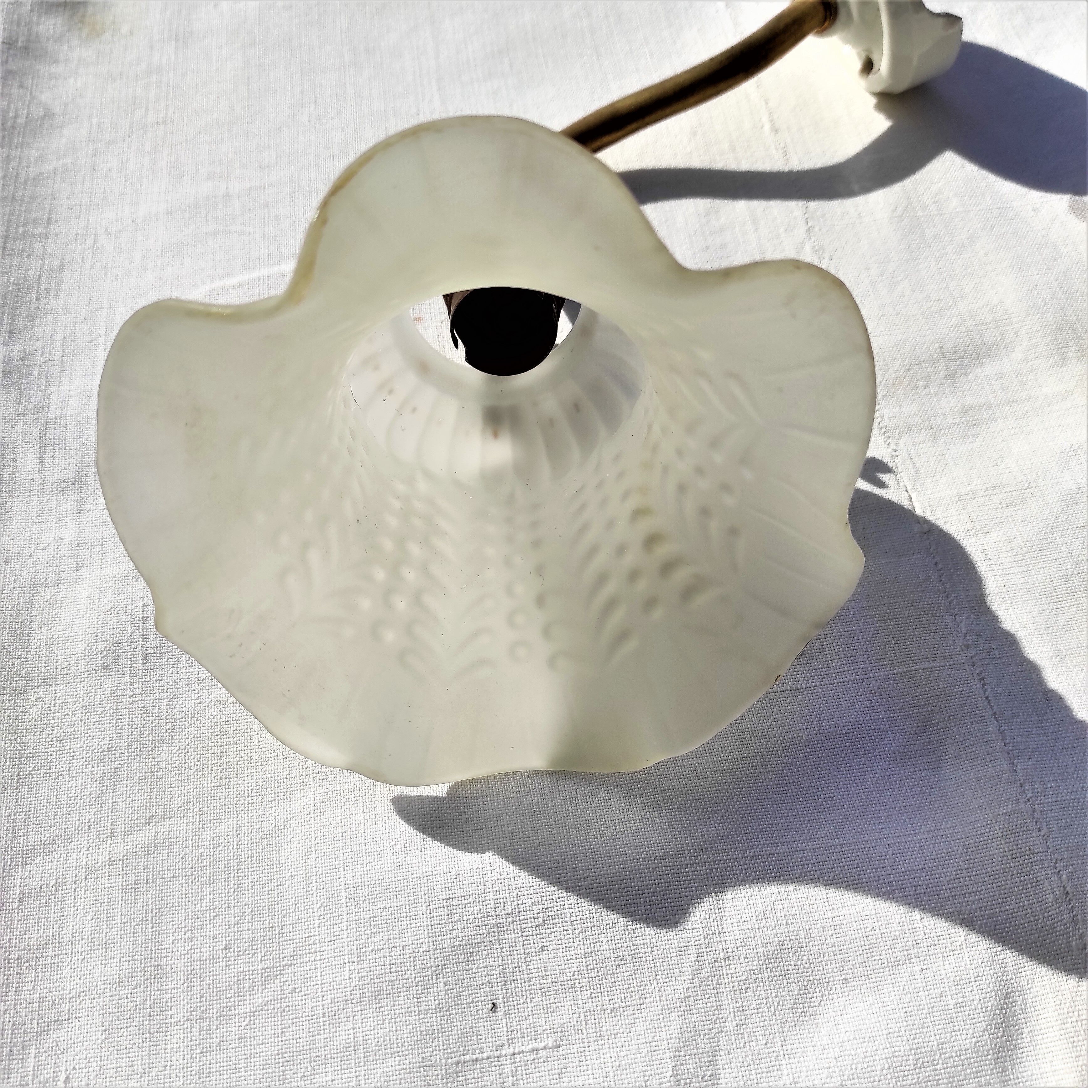 Brass gooseneck wall lamp, with brass socket and porcelain base.