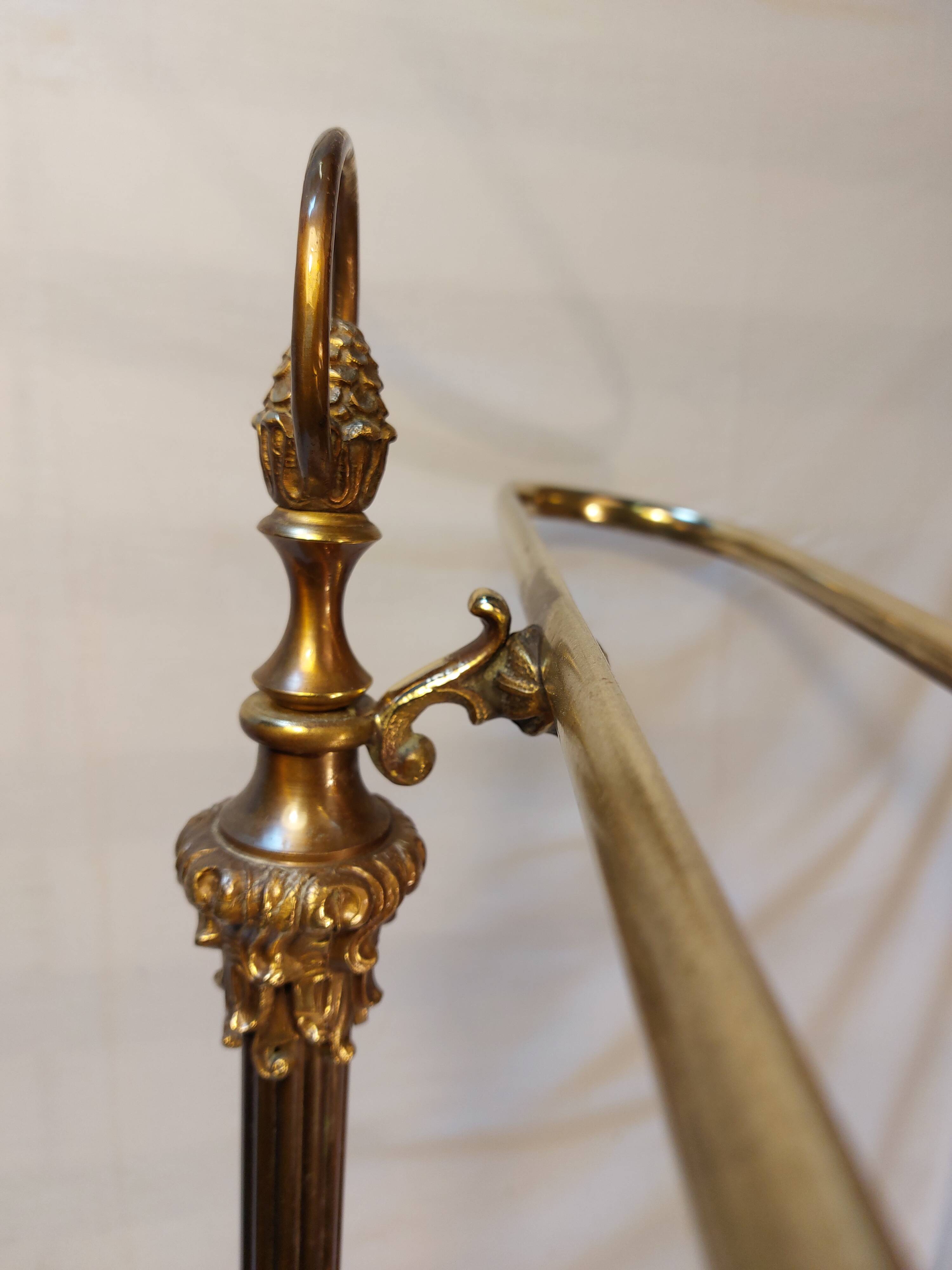 Old golden brass towel rack on baroque style foot
