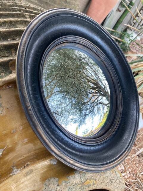 Convex mirror, also known as a witch's mirror.