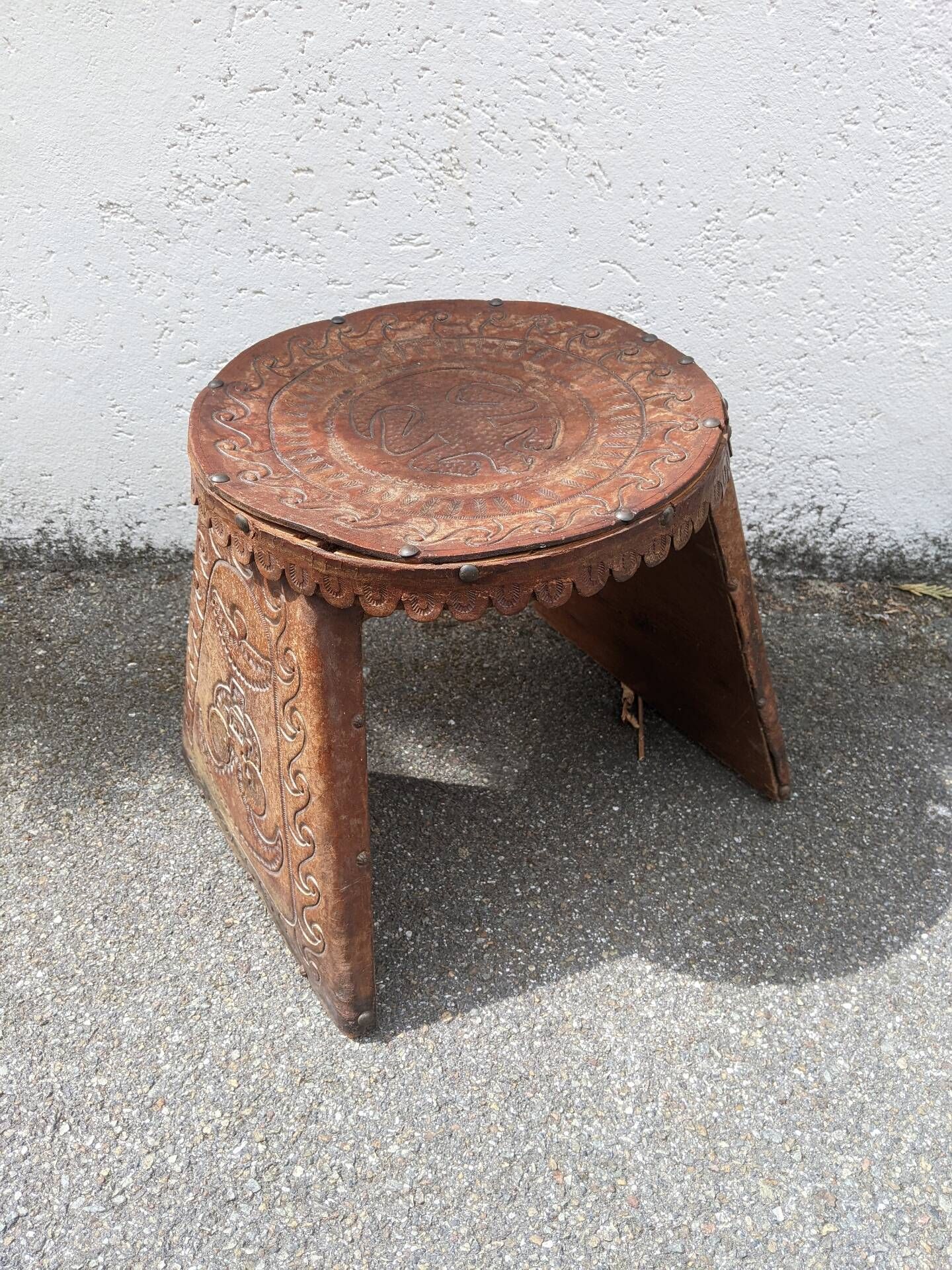 Wood and leather stool, handcrafted African art.