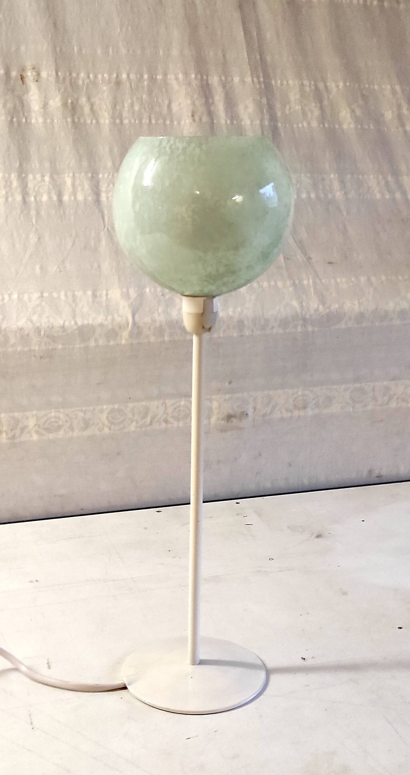 Table lamp with a pale green Clichy glass globe.