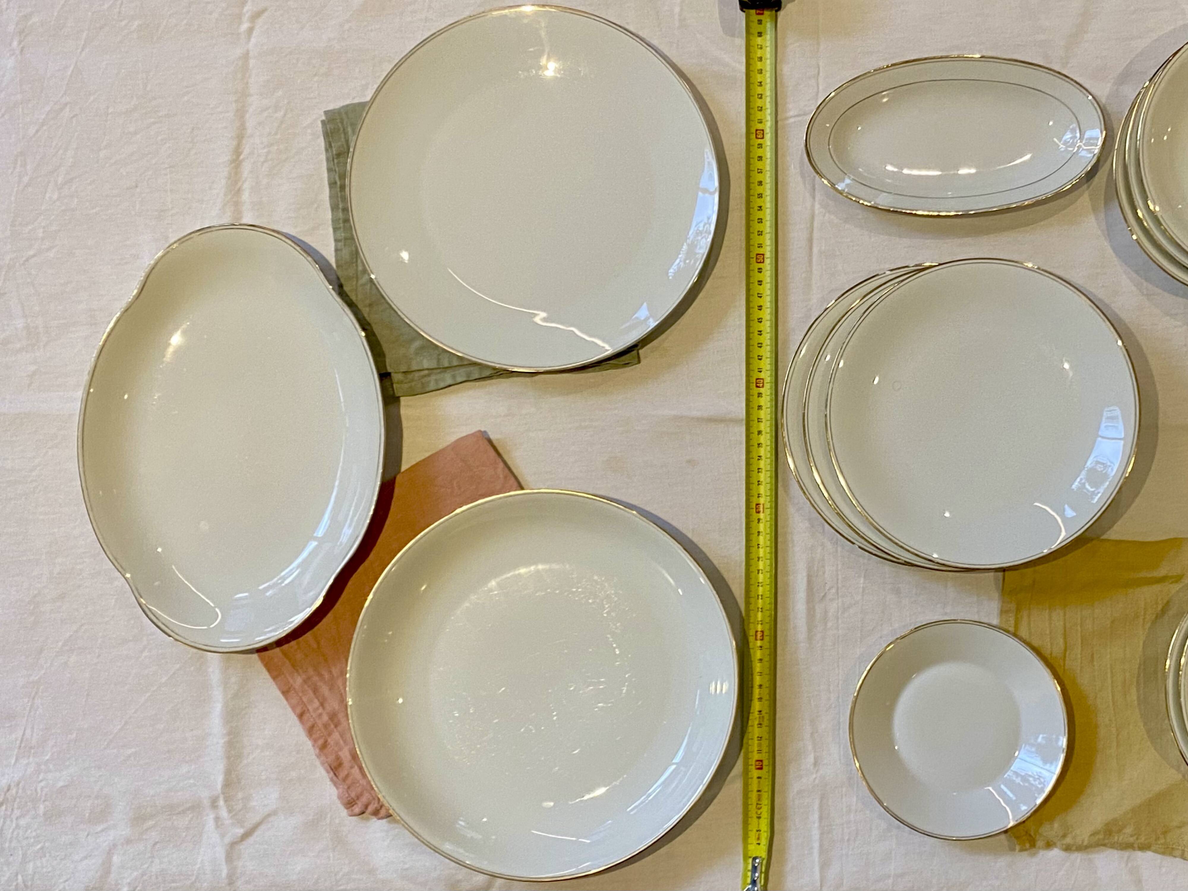 Vintage table service Limoges porcelain white with gold trim.